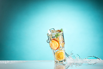 Image showing The rose exotic cocktail and fruit on blue