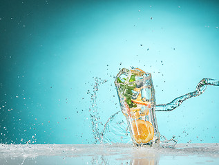 Image showing The rose exotic cocktail and fruit on blue