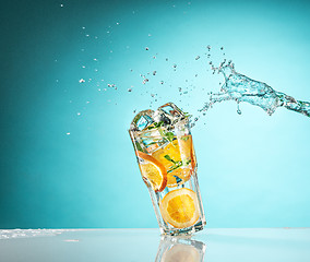 Image showing The rose exotic cocktail and fruit on blue