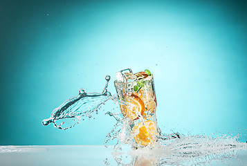 Image showing The rose exotic cocktail and fruit on blue