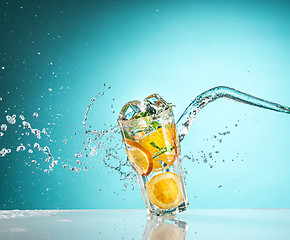 Image showing The rose exotic cocktail and fruit on blue