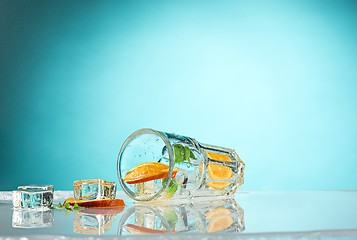 Image showing The rose exotic cocktail and fruit on blue