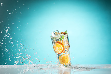 Image showing The rose exotic cocktail and fruit on blue