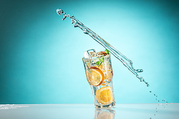 Image showing The rose exotic cocktail and fruit on blue