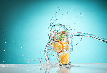 Image showing The rose exotic cocktail and fruit on blue