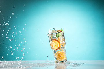 Image showing The rose exotic cocktail and fruit on blue