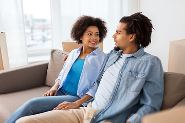 Image showing happy couple sitting on sofa and talking at home