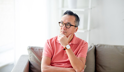 Image showing asian man thinking at home