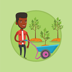 Image showing Man pushing wheelbarrow with plant.