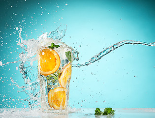 Image showing The rose exotic cocktail and fruit on blue