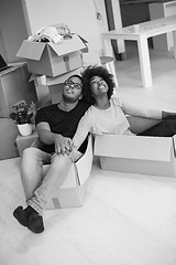 Image showing African American couple  playing with packing material