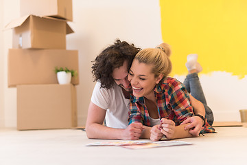 Image showing Happy young couple relaxing after painting