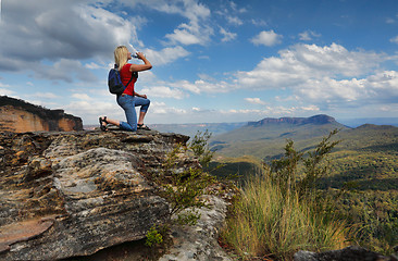 Image showing Woman drinking water on mountain summit Australia