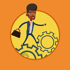 Image showing Business man running on cogwheels.