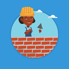 Image showing Bricklayer working with spatula and brick.