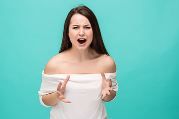 Image showing Frustrated young woman posing on blue