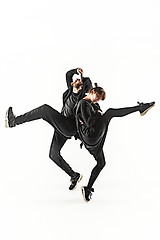 Image showing The silhouettes of two hip hop male and female break dancers dancing on white background