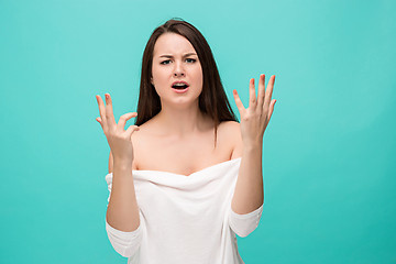 Image showing Frustrated young woman posing on blue