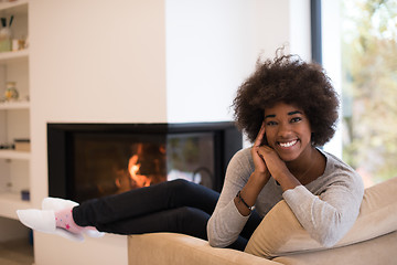 Image showing black woman in front of fireplace