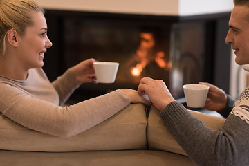 Image showing Young couple  in front of fireplace