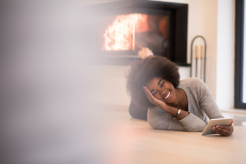 Image showing black women using tablet computer on the floor