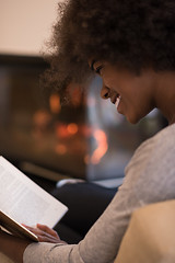 Image showing black woman at home reading book