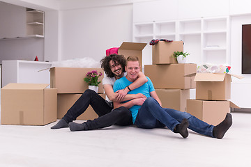 Image showing young  gay couple moving  in new house