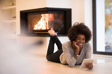 Image showing black women using tablet computer on the floor