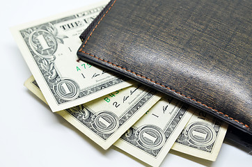 Image showing Money sticking out of a leather wallet