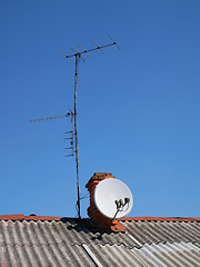 Image showing Antennas on the roof of an old house