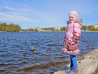 Image showing Schoolgirl on the dam in early spring