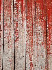 Image showing Old wooden planks with shelled red paint