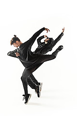 Image showing The silhouettes of two hip hop male and female break dancers dancing on white background