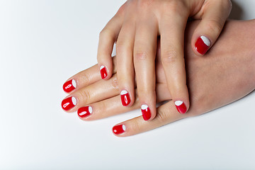 Image showing Female hands with red and white nails