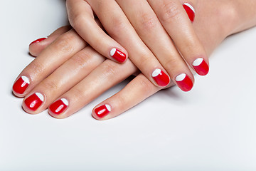 Image showing Female hands with red and white nails