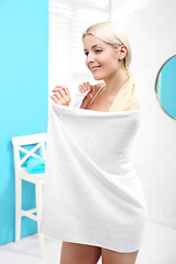 Image showing A woman wipes the body with a towel