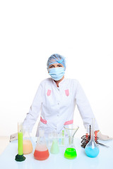 Image showing Woman chemist and chemicals in flasks