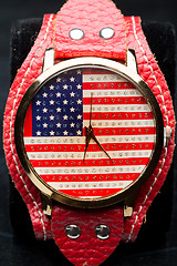 Image showing clock on a black background. American Flag