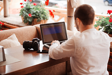 Image showing Man is looking at laptop with excitement.