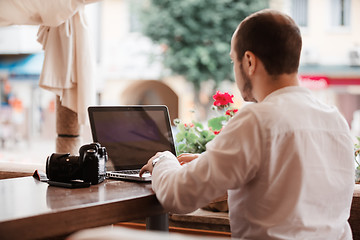 Image showing Man is looking at laptop with excitement.