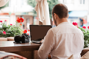 Image showing Man is looking at laptop with excitement.