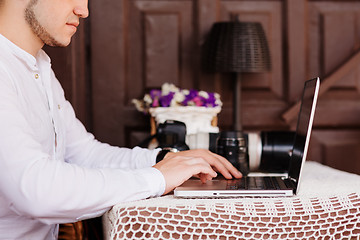 Image showing Man is looking at laptop with excitement.