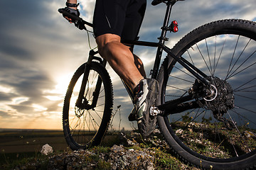 Image showing Sportive man with bicycle at sunset