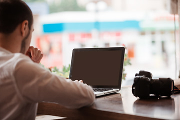 Image showing Man is looking at laptop with excitement.