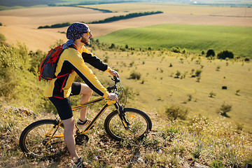 Image showing young bright man on mountain bike