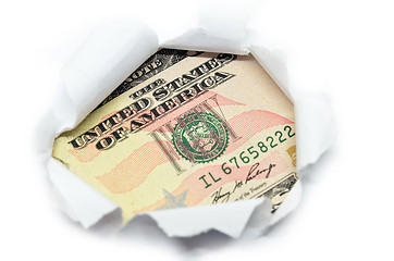 Image showing US currency peeking through white paper.