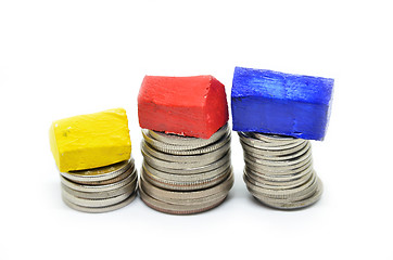 Image showing Coins stacked up in piles with color house