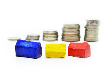 Image showing Coins Stacked up in piles with color house