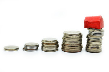 Image showing Coins stacked up in piles with color house