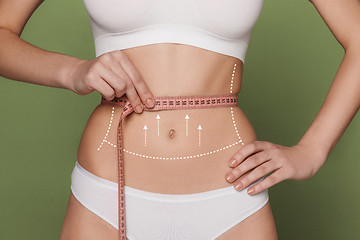 Image showing Women belly with the drawing arrows